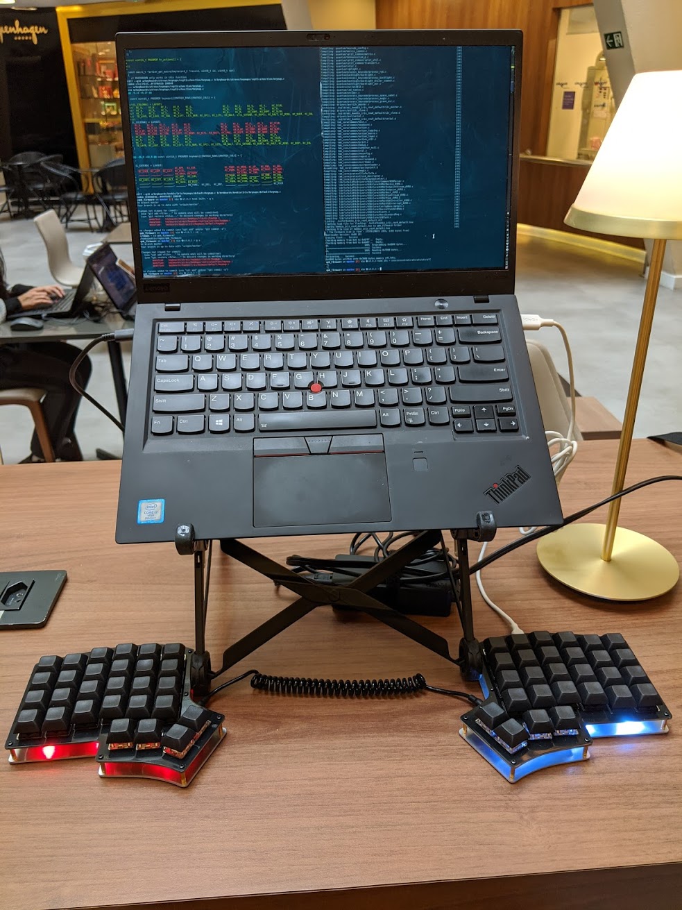 The laptop mounted on a Roost stand and the keyboard below. One side with right LEDs and the other with blue LEDs