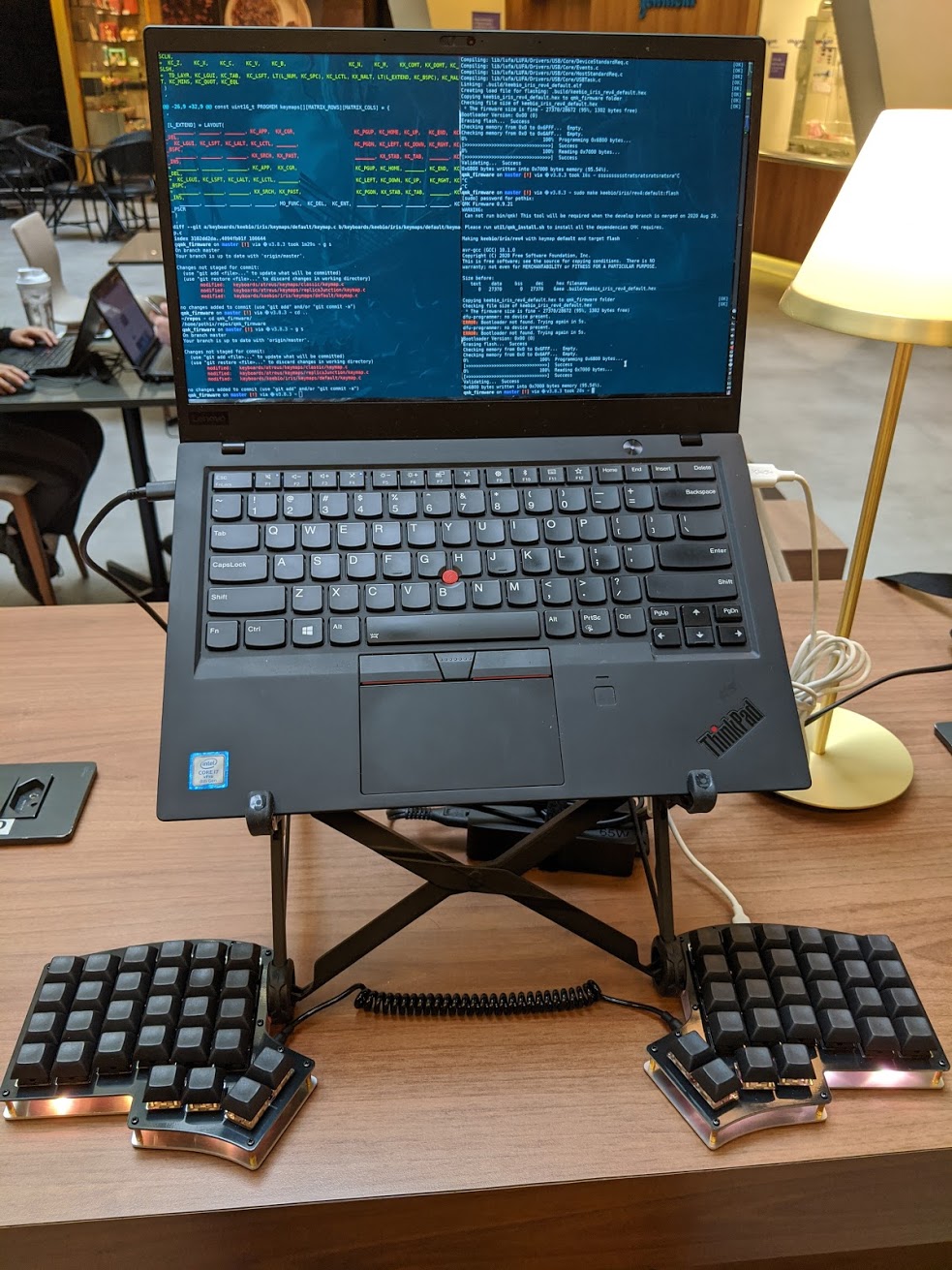 The laptop mounted on a Roost stand and the keyboard below. The keyboard showing an yellow LED color